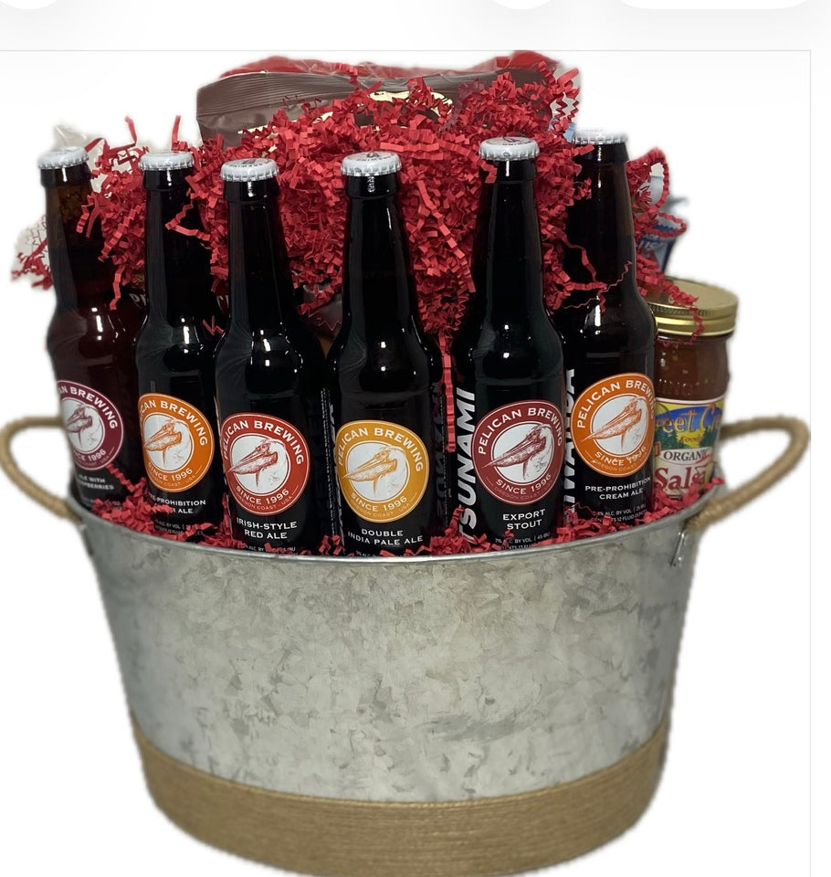 A gift basket set featuring six dark beer bottles  arranged in a galvanized metal bucket with red crinkle paper filler, and a jar of salsa on a white  background.