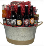 Metal container with twine on the base and on the handles with Pacific Northwest sodas, beer and snacks.