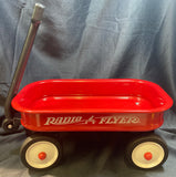 Red Radio Flyer wagon on a gray background