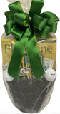 Golf-themed gift basket with green ribbon, golf balls, and golf card games on a white background