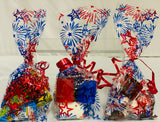 Decorative gift bags with red, white, and blue designs on a white background