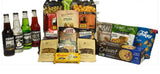 A variety of snack and beverage products arranged together on a white background, including four bottles of soda, bags of popcorn, pretzels, chips, cookies, and crackers.