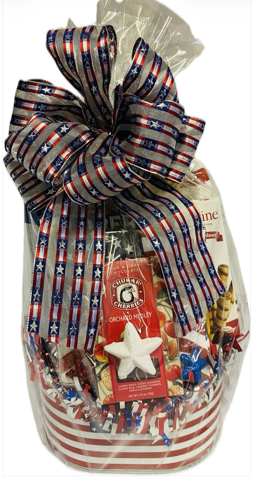 Gift basket with American flag ribbon and various items including a star-shaped candy.