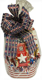 Gift basket with American flag ribbon and various items including a star-shaped candy.