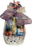 Gift basket with patriotic theme featuring sparkling white grape juice and snacks tied with a plaid ribbon.